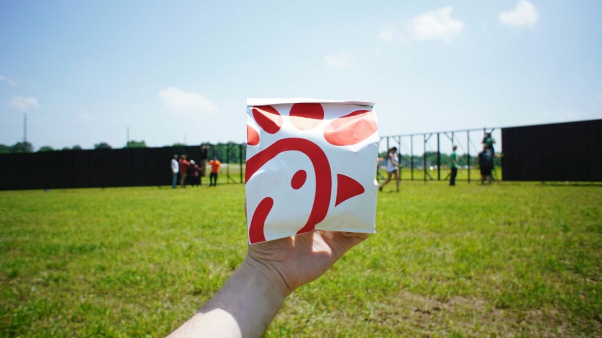 person holding a paper box of Chick-fil-A
