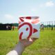 person holding a paper box of Chick-fil-A