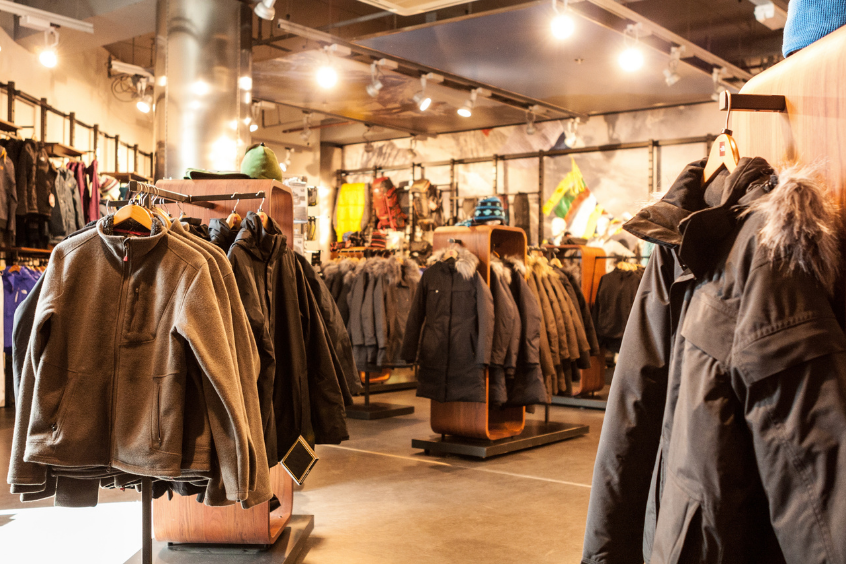 Interior of an outdoor apparel retail store with racks filled with cold-weather clothing 