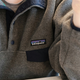 Close-up photo of a gray fleece jacket with Patagonia logo
