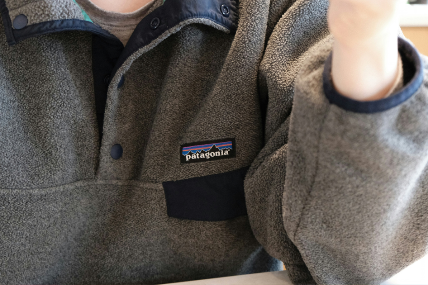 Close-up photo of a gray fleece jacket with Patagonia logo