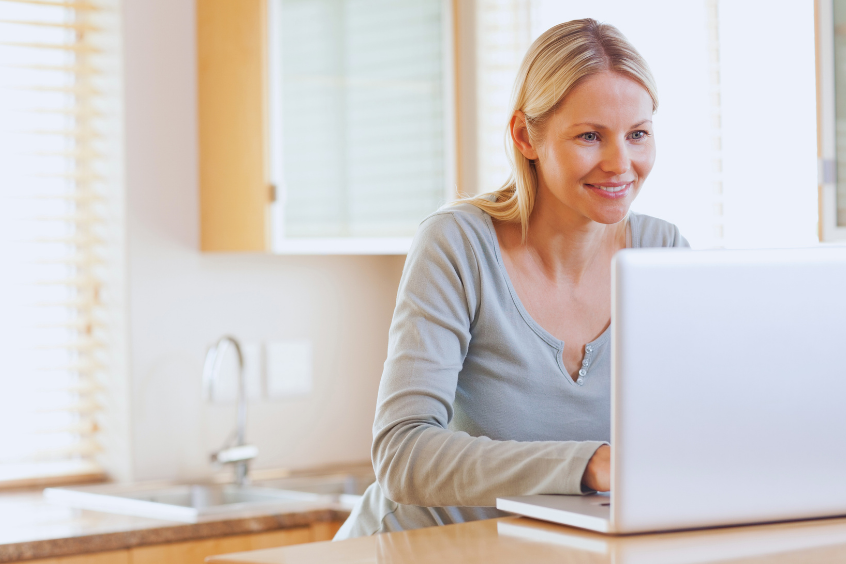Smiling woman typing on her laptop